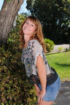 Redhead MILF Sophia K removes jean shorts as she disrobes under patio tree on pornstar6.com