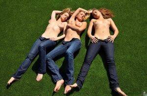 3 topless girls pull their blue jeans down over their bare asses on the lawn on pornstar6.com