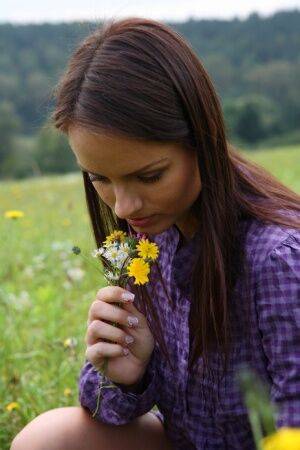 Young girl gets totally naked while picking flowers in a rural field on pornstar6.com