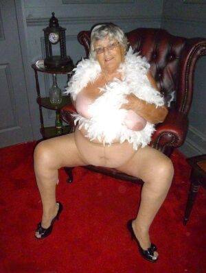 Fat nan Grandma Libby wears a feather boa while baring her saggy tits and butt on pornstar6.com