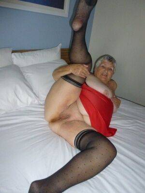 Fat man Grandma Libby doffs her lingerie before masturbating on her bed on pornstar6.com
