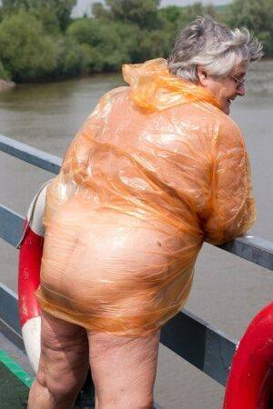 Obese oma Grandma Libby doffs a see-through raincoat to get naked on a bridge on pornstar6.com
