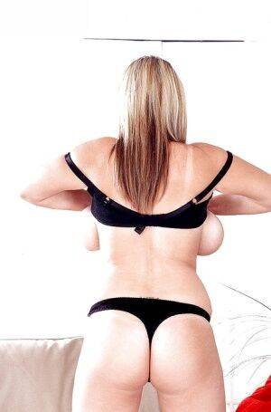 Blonde European MILF pornstar Kelly Kay unleashing huge boobs from lingerie on pornstar6.com