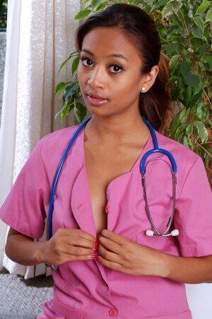 Amateur black babe bares shaved teen pussy after shedding nurse uniform on pornstar6.com