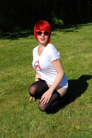 Redheaded amateur Sabrina soaks her white T-shirt out on a lawn in sunglasses on pornstar6.com