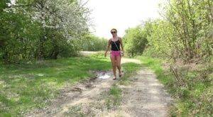 White girl Dafne pisses in a mud puddle while out for a walk in sunglasses on pornstar6.com