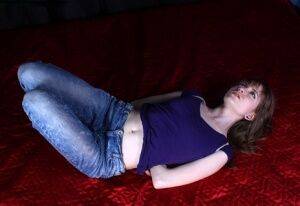 Barefoot white girl Agnes is hogtied in a shirt and blue jeans on pornstar6.com