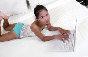 Petite Asian girl launches her nude modeling career atop white bed sheets on pornstar6.com