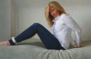 Blonde woman is cleave gagged and hogtied in a white blouse and blue jeans on pornstar6.com