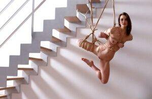 Naked white girl is suspended in midair by ropes with no one else around on pornstar6.com