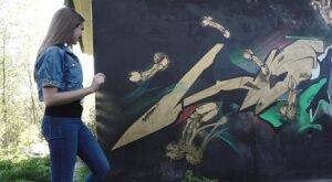 White girl Viktoria pulls down her jeans to take a pee near a wall of graffiti on pornstar6.com