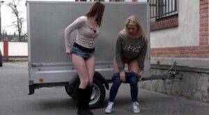 Katy Sky and Victoria Daniels duck behind a trailer for a much needed piss on pornstar6.com