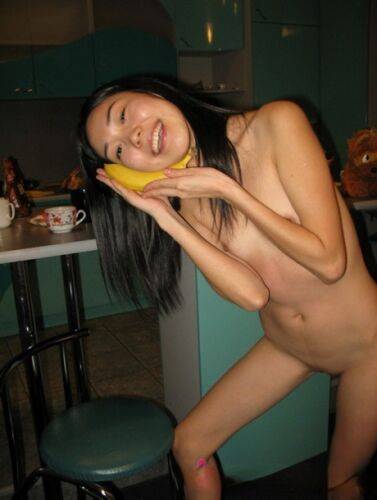 Skinny Filipina teen Nicoline Yiki fools around with a banana while bare naked on pornstar6.com