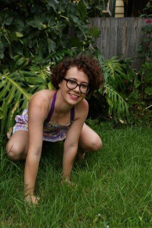 Geeky girl Rosie wears her glasses for her nude debut on the back lawn on pornstar6.com