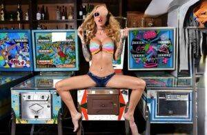 Inked chick Sarah Jessie toys her pussy atop a pinball machine while alone on pornstar6.com