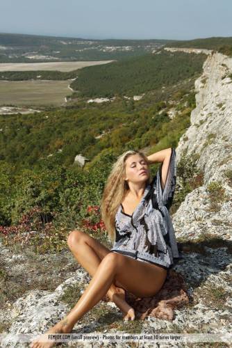 The Blonde Chick April E Has Climbed The Rocks To Expose The Nude Body To The Skies on pornstar6.com