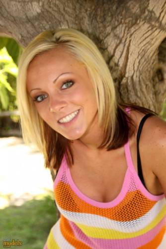 Smiling Blonde Kitty Cali Kayden Shows Her Bald Pussy In The Shadow Of A Tree on pornstar6.com
