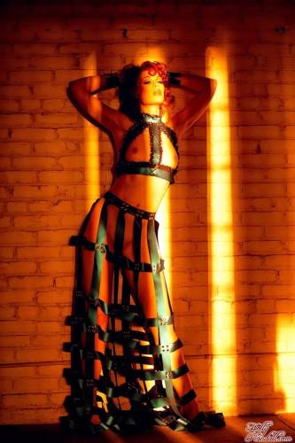 Redhead Justine Joli In Amazing Dress Made Of Leather Belts Poses In The Empty Room on pornstar6.com